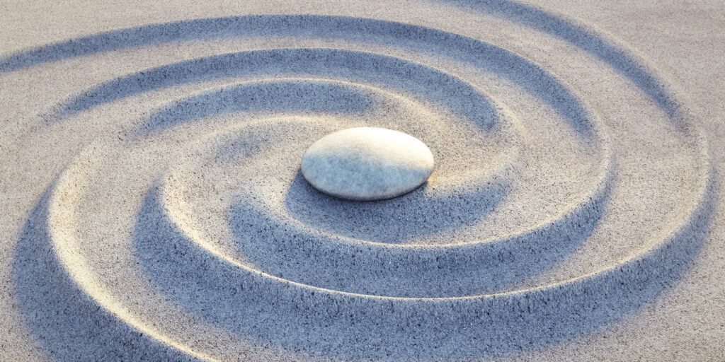 japanese zen garden with sand waves spiral and single stone